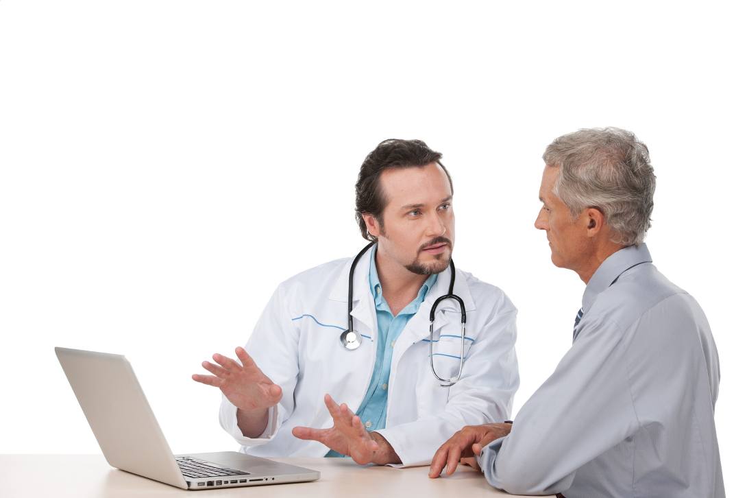 Doctor with laptop explaining to a senior patient